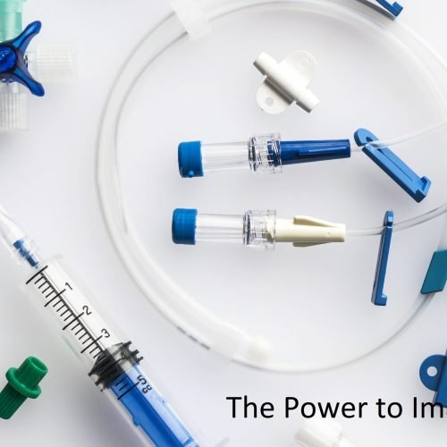 Neatly arranged syringe with needle and plastic tubes for central venous catheter insertion on a white background